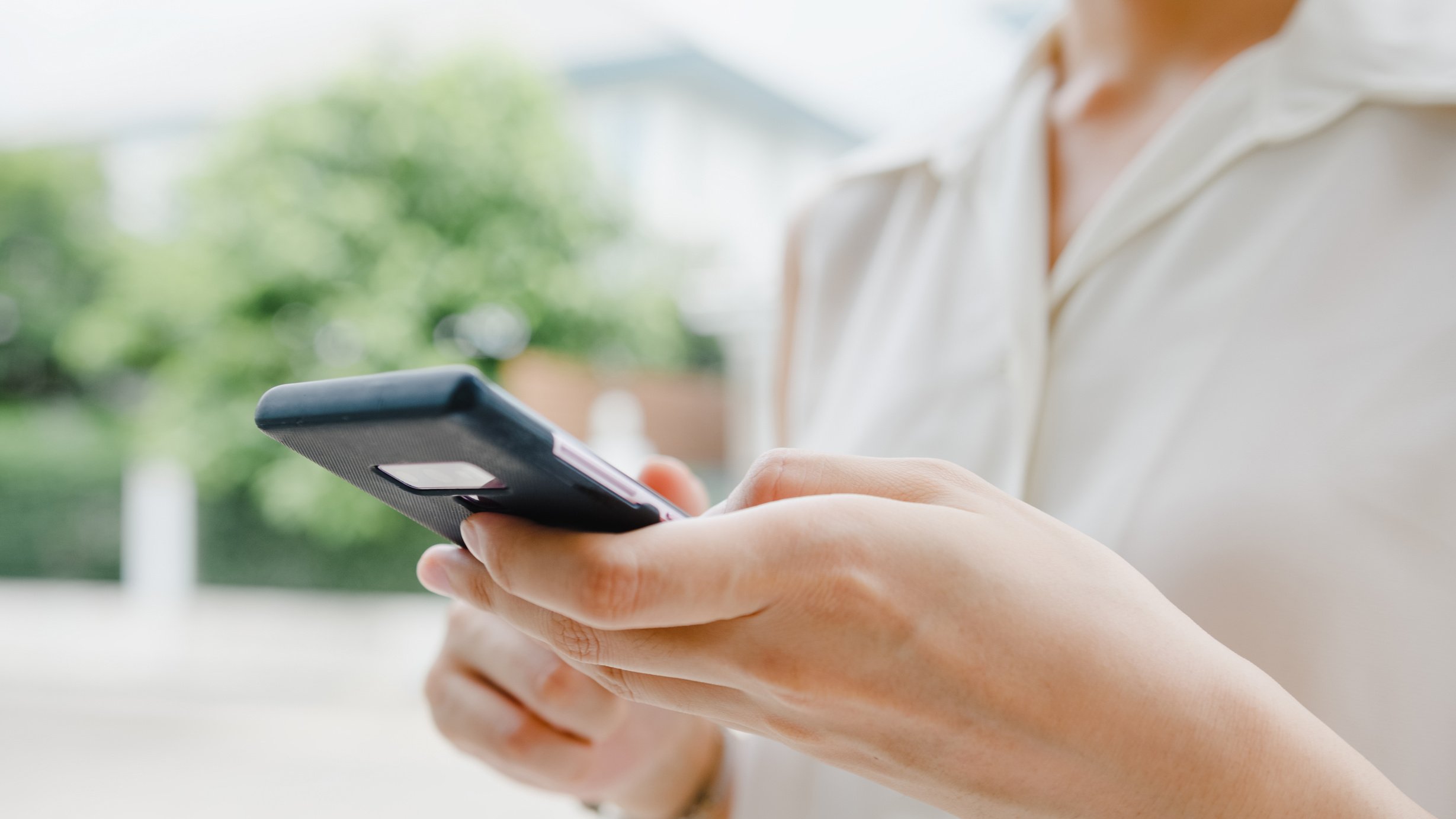 Attractive young Asia businesswoman using mobile phone check